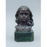 A bronze bust of a young girl on a plinth base. 15 cm high.