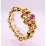 A Russian high carat gold bracelet of engraved link form, centred with a cabochon ruby,