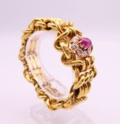 A Russian high carat gold bracelet of engraved link form, centred with a cabochon ruby,