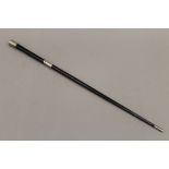 An ebony and silver stick/baton. 51.5 cm long.