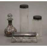 An unmarked silver overlay scent bottle and three silver topped jars. The former 9 cm high.