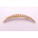 A 15 ct gold, seed pearl crescent moon form brooch. 5 cm high. 3.7 grammes total weight.