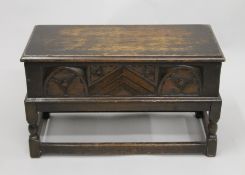 An early 20th century small carved trunk on stand. 60.5 cm wide.