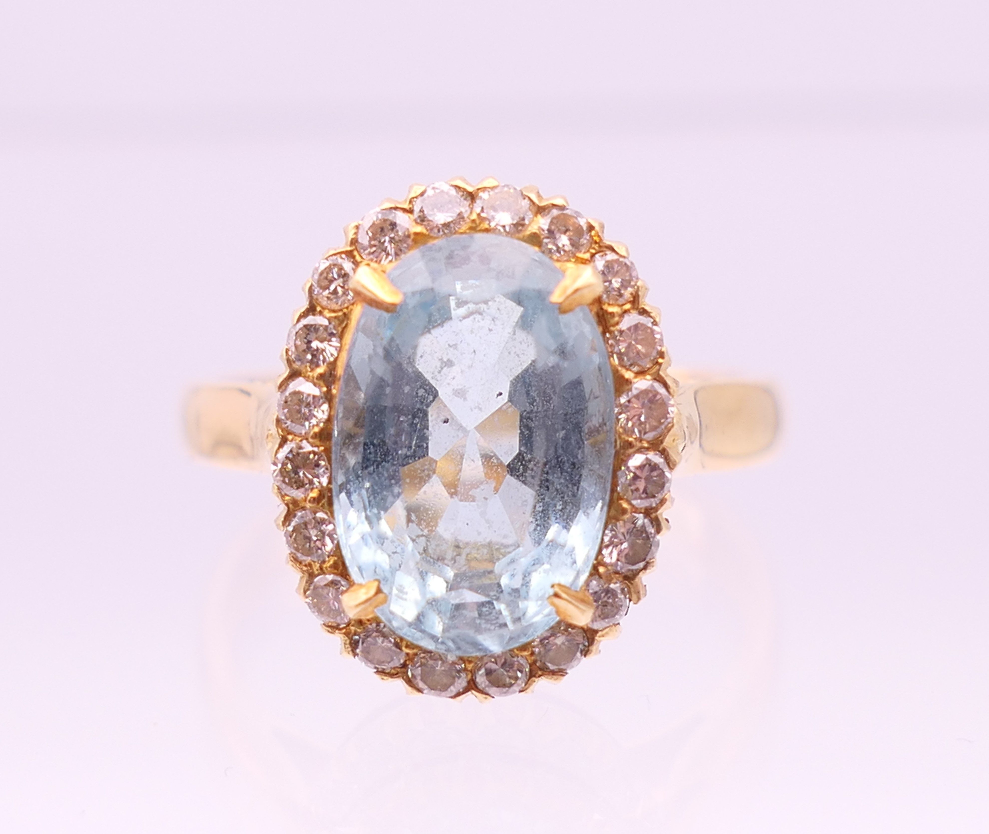 An 18 ct gold diamond and aquamarine ring. Ring size M/N.