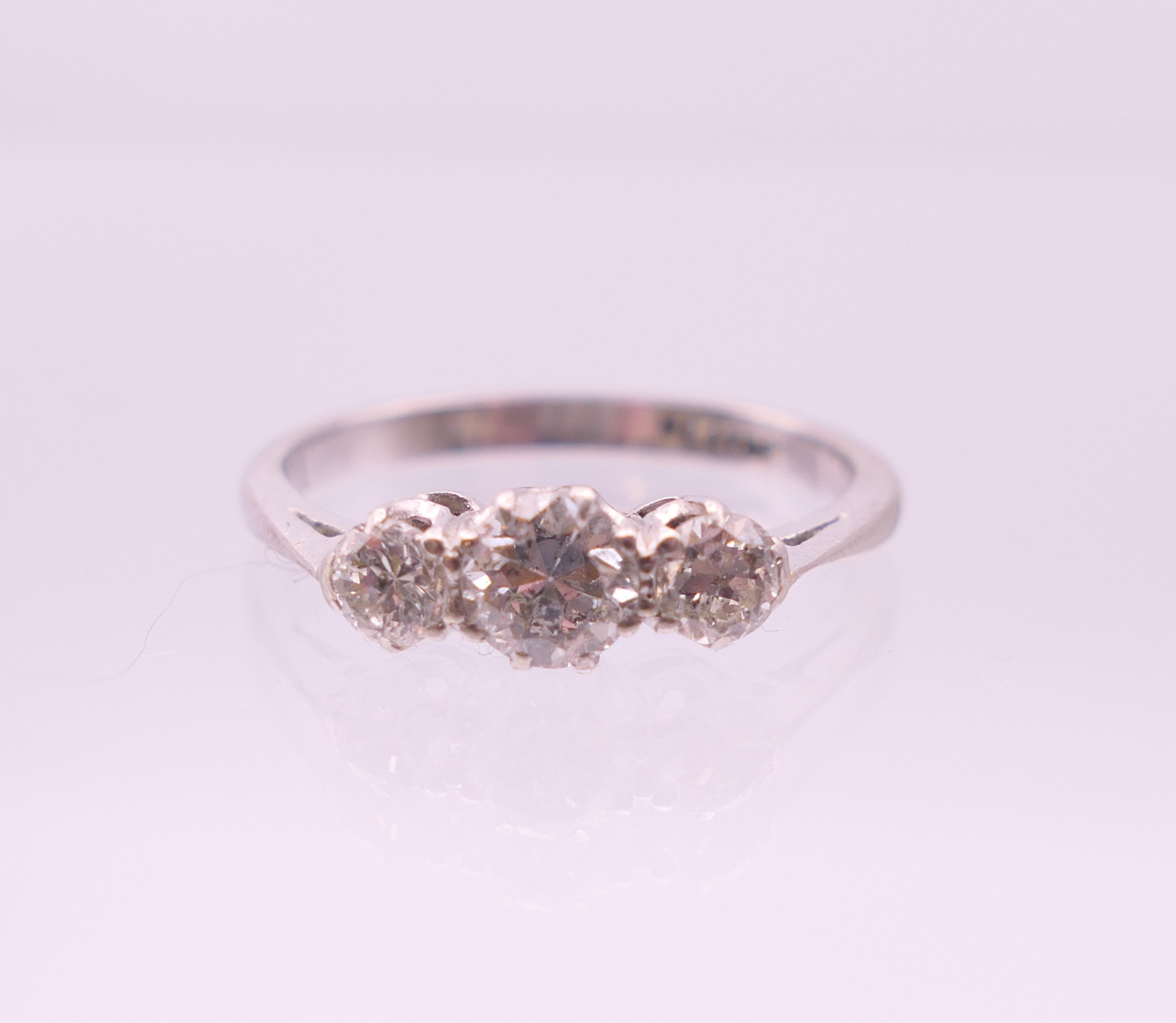 A platinum three stone diamond ring. Ring size P. - Image 2 of 7