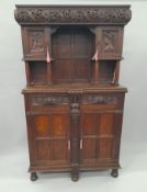 A Victorian carved oak side cupboard. 106 cm wide.