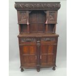 A Victorian carved oak side cupboard. 106 cm wide.