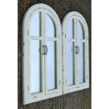 A pair of white painted arch mirrors. 53.5 cm wide x 100 cm high.