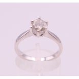 An 18 ct white gold diamond solitaire ring, the stone approximately 0.8 carat. Ring size M.