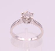 An 18 ct white gold diamond solitaire ring, the stone approximately 0.8 carat. Ring size M.