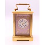 A miniature porcelain mounted carriage clock. 6 cm high.