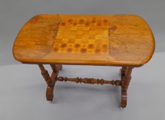 A Victorian inlaid walnut games table. 87 cm long.