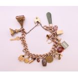 A 9 ct gold charm bracelet. Approximately 20 cm long. 57.8 grammes total weight.