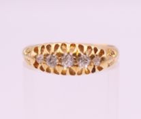 An 18 ct gold five stone diamond ring. Ring size L/M. 3.6 grammes total weight.