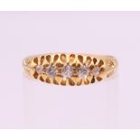 An 18 ct gold five stone diamond ring. Ring size L/M. 3.6 grammes total weight.