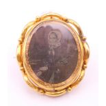 A 19th century unmarked 9 ct gold reversible mourning brooch. 6 cm high.