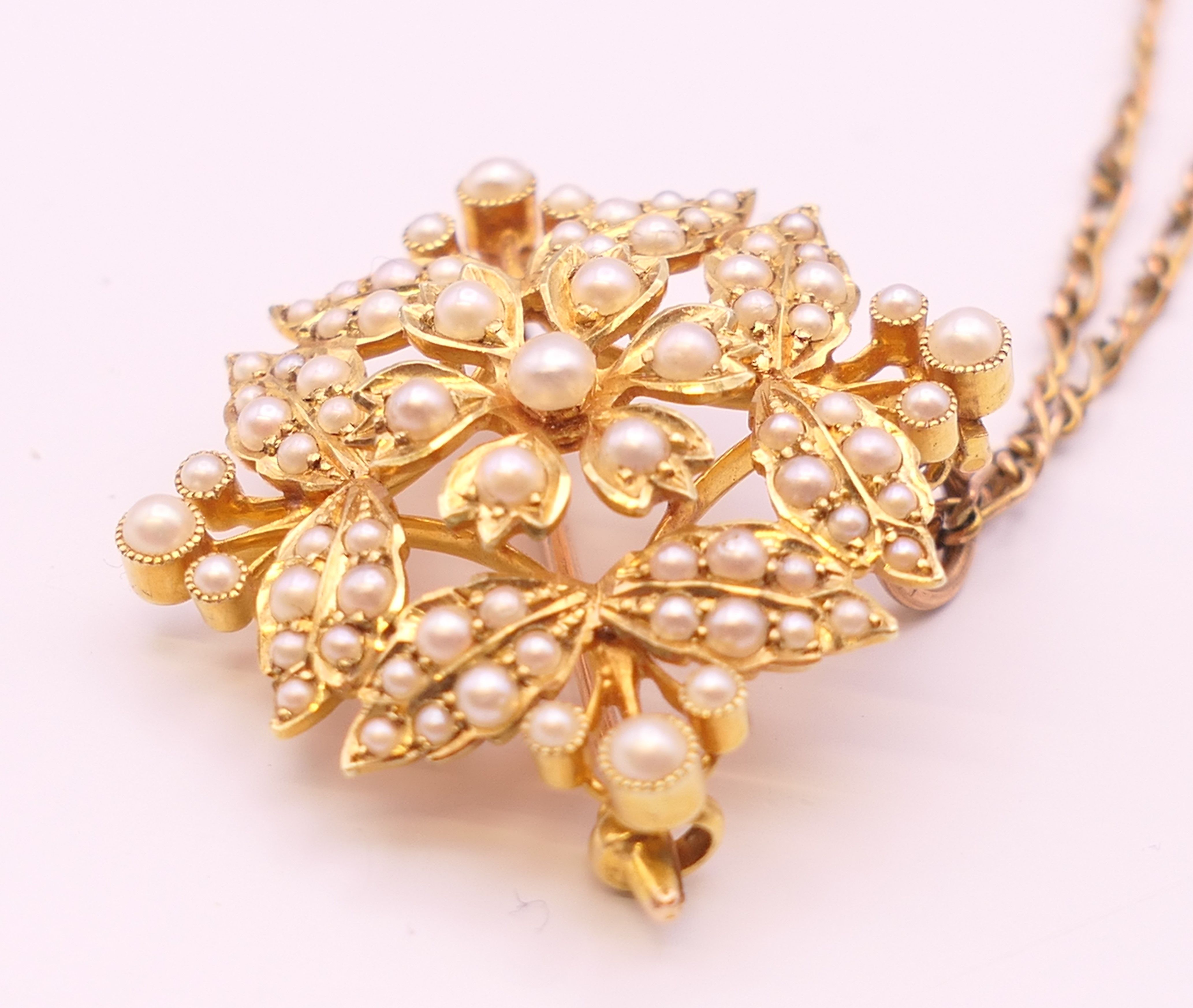 A 15 ct gold and seed pearl pendant/brooch on a 9 ct gold chain. - Image 3 of 9