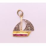 A diamond and ruby sailing boat form charm. 1.5 cm high.