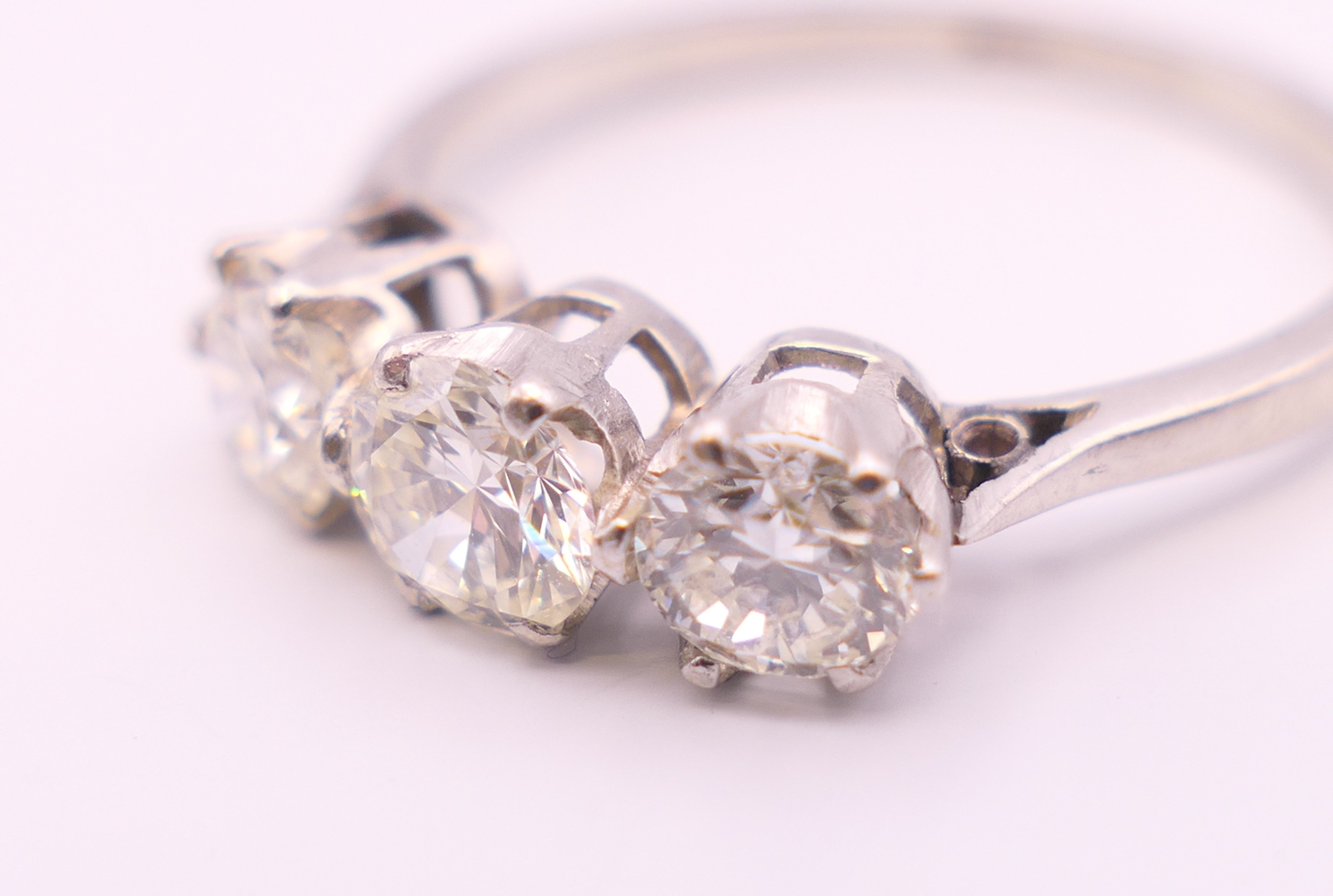 A platinum diamond trilogy ring. The total diamond weight approximately .8 carat. estimate. - Image 5 of 8