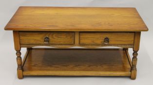 A modern two drawer oak coffee table. 106 cm long.