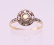 A gold and platinum diamond target ring. Ring size O/P.