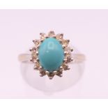 An 18 ct white gold diamond and turquoise ring. Ring size M/N.