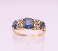 An 18 ct gold, sapphire and diamond ring. Ring size K/L.