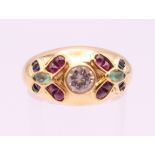 An 18 ct gold diamond, sapphire, ruby and emerald ring. Ring size M.