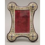 A cabochon set silver and enamel mounted photograph frame, bearing Russian marks. 24 cm high.