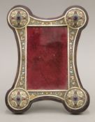 A cabochon set silver and enamel mounted photograph frame, bearing Russian marks. 24 cm high.