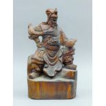 A Chinese carving of a warrior. 33 cm high.