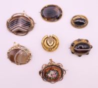 A quantity of Victorian brooches including banded agate. Largest 5.5 cm wide.