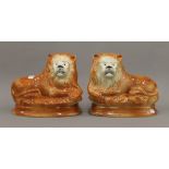 Two Staffordshire pottery lions. 30 cm long.