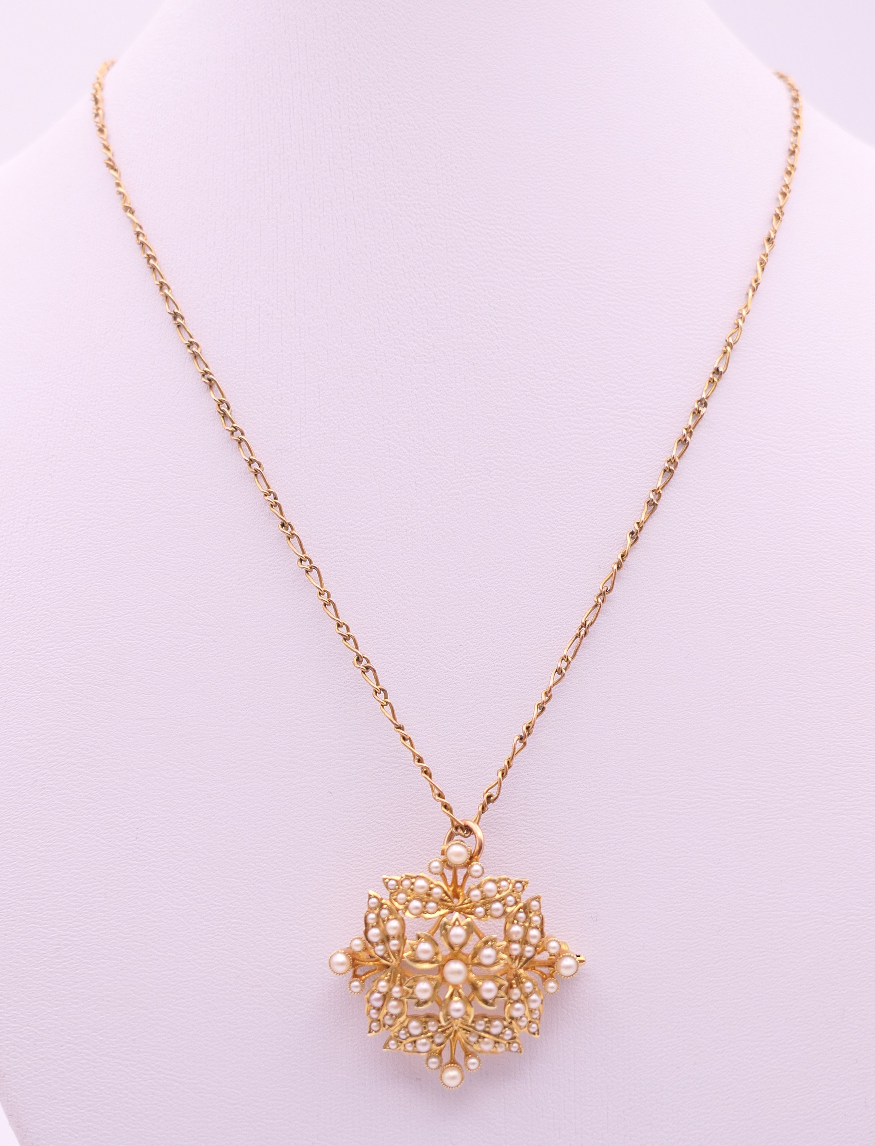 A 15 ct gold and seed pearl pendant/brooch on a 9 ct gold chain. - Image 9 of 9