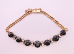 An 18 ct gold, sapphire and diamond bracelet. Approximately 18 cm long. 16.5 grammes total weight.