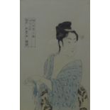 A Japanese print of a woman, framed and glazed. 23.5 x 38 cm.