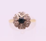 An 18 ct gold diamond and sapphire ring. Ring size L/M. 3.9 grammes total weight.