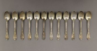A cased set of twelve silver teaspoons, in Maple & Co box. 165.5 grammes.