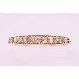An unmarked gold diamond set bracelet. The largest stone spreading to approximately .5 carat. 5.