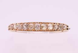 An unmarked gold diamond set bracelet. The largest stone spreading to approximately .5 carat. 5.