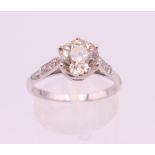A platinum and diamond ring, the central claw set stone spreading to approximately 2 carats,