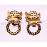 A pair of 18 K gold, ruby, diamond and enamel leopard mask form earrings. 2 cm high. 18.