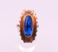 A 8 K gold blue stone ring. Ring size T. 6.8 grammes total weight.