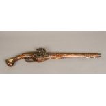 A bone and mother-of-pearl inlaid wheel lock pistol. 63.5 cm long.