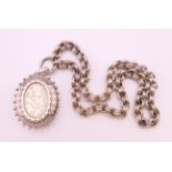 A Victorian silver locket on chain.