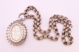 A Victorian silver locket on chain.