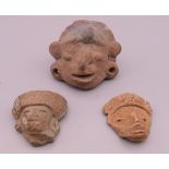 A small quantity of antiquity type pottery masks. Largest 5 cm high.