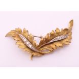 A Continental gold and diamond leaf form brooch. 5.5 cm long. 11.5 grammes total weight.