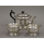 A silver three piece tea set. The teapot 24 cm long. 625.4 grammes total weight.