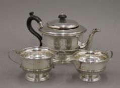 A silver three piece tea set. The teapot 24 cm long. 625.4 grammes total weight.